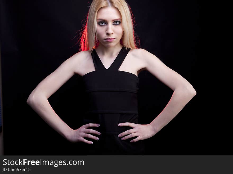 Gorgeous blonde model with a red light behind her studio shot