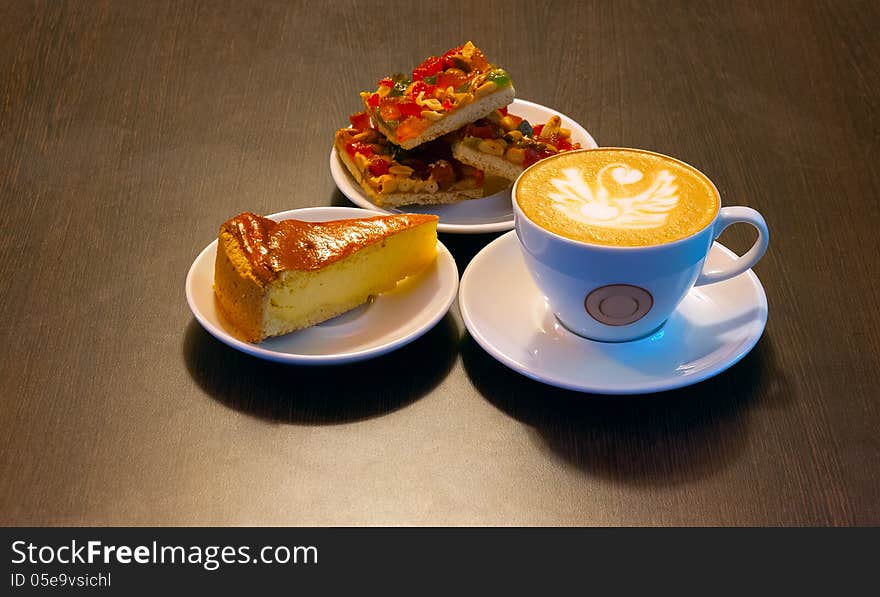 On a wooden table are white plates with cookies and cake. On a wooden table are white plates with cookies and cake