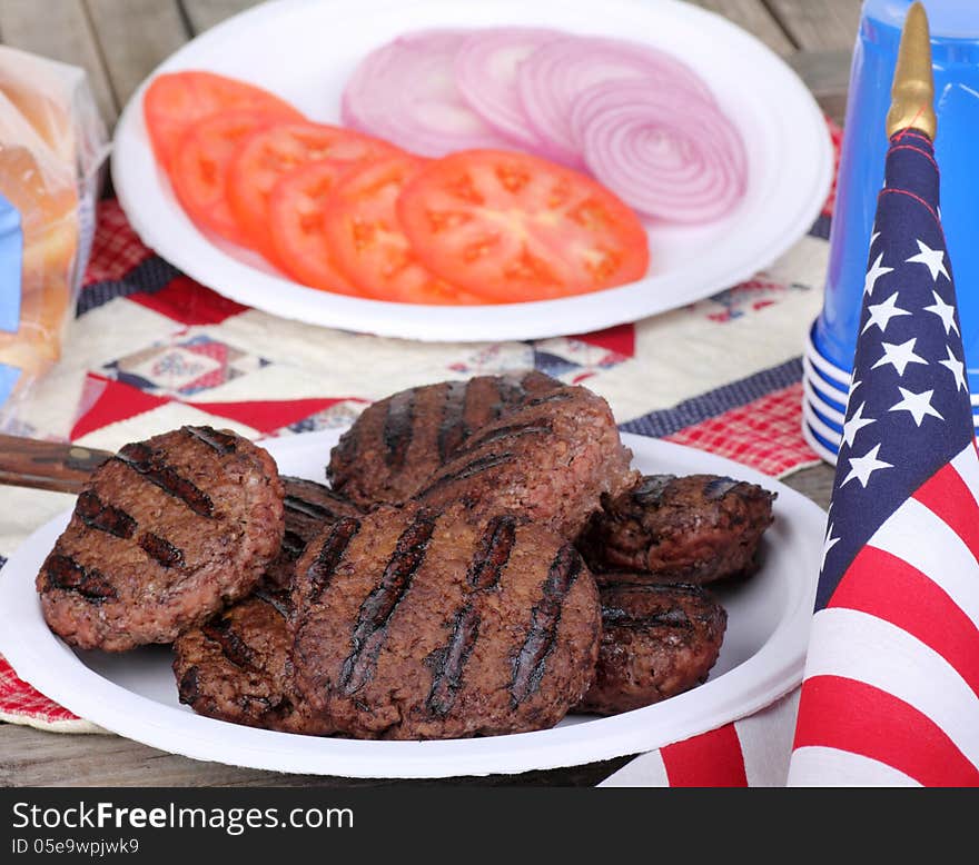 Grilled hamburgers on a plate with american flag. Grilled hamburgers on a plate with american flag