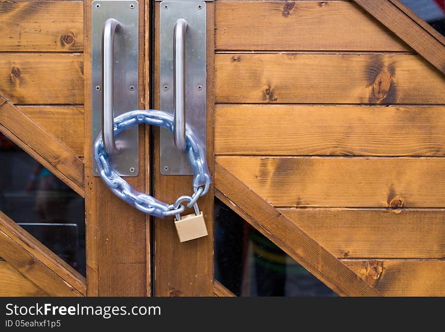 Iron lock and chain on wood door