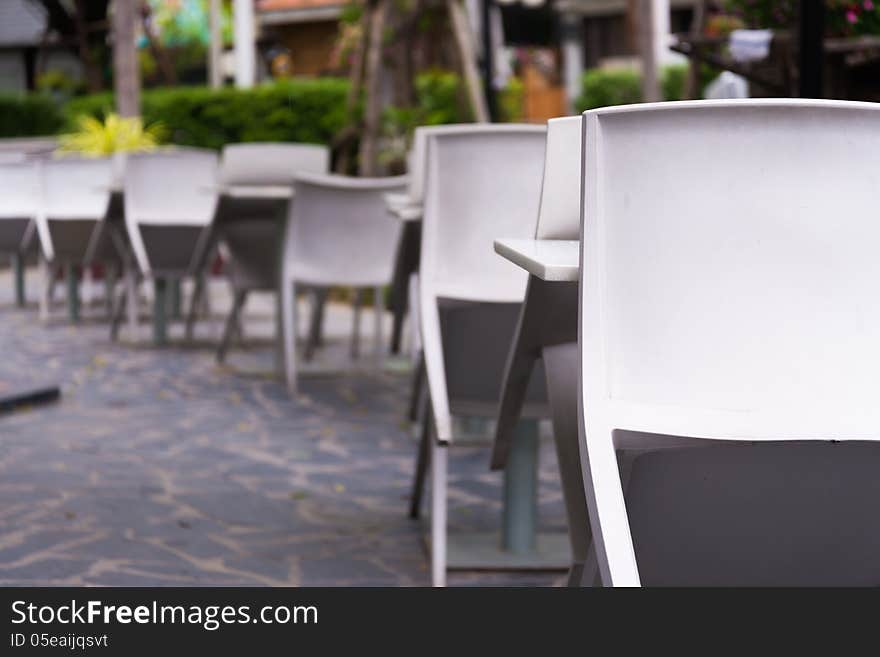 Outdoor restaurant with white desks and chairs