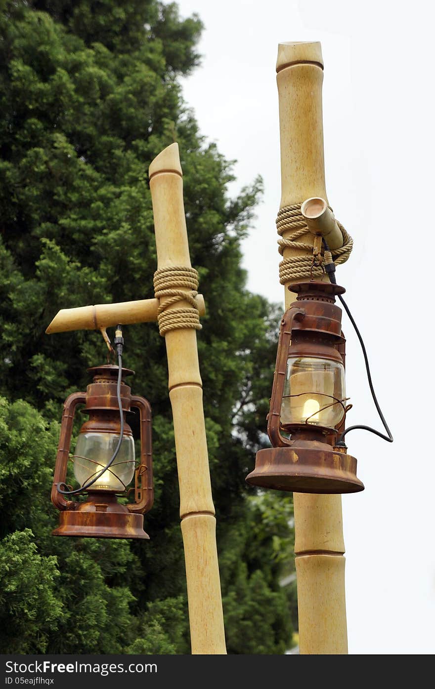 Hanging lamps on bamboo posts.