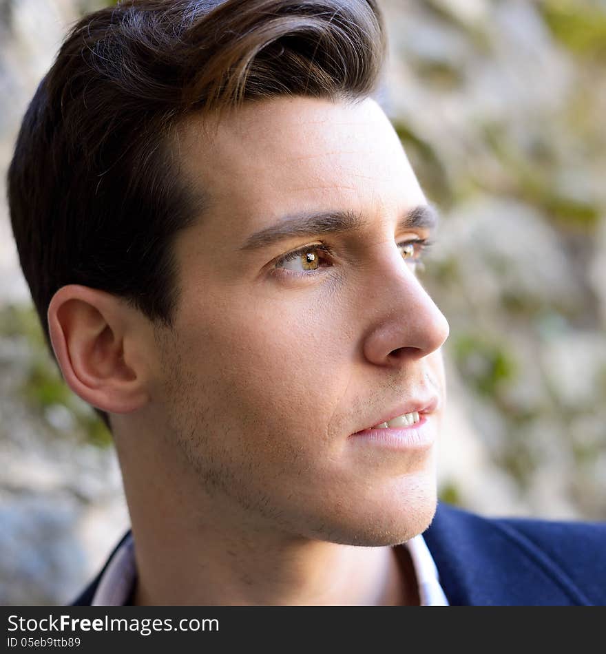 Handsome Man With Modern Hairstyle Smiling In Urban Background