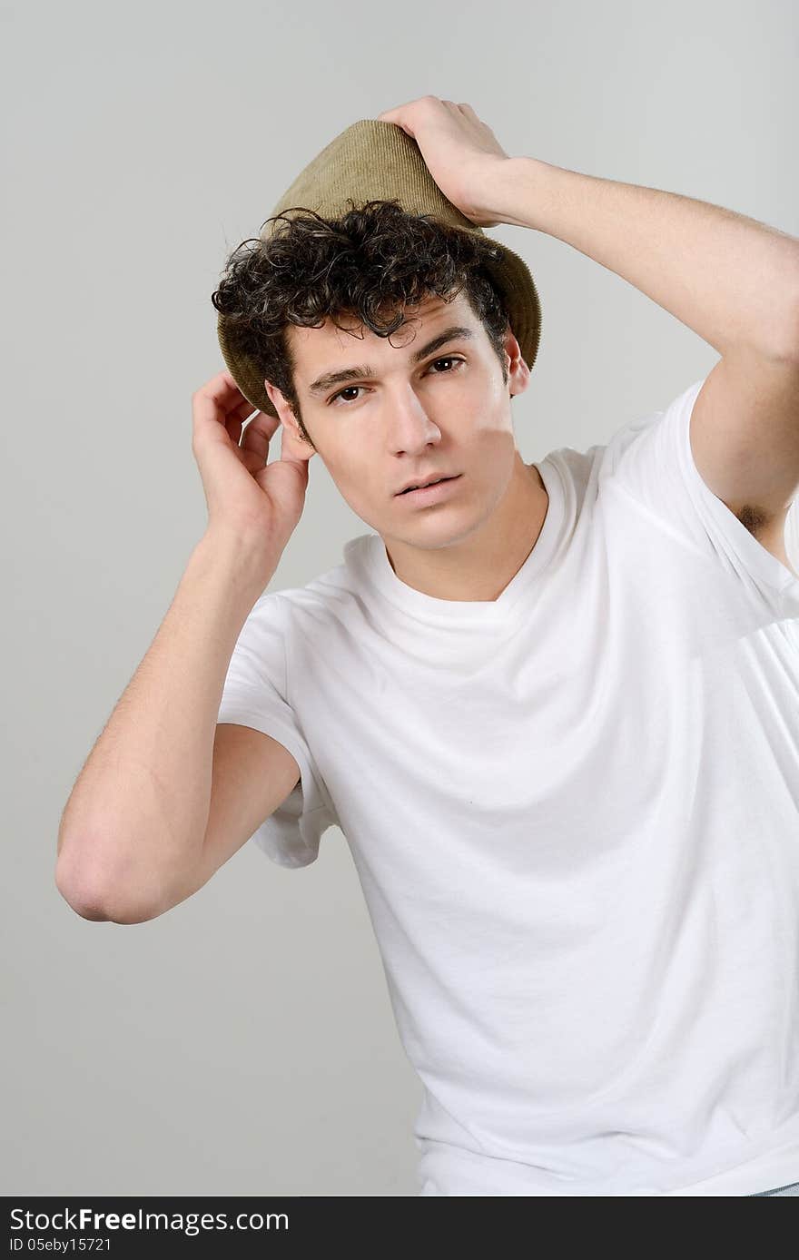 Handsome young man with hat on white background