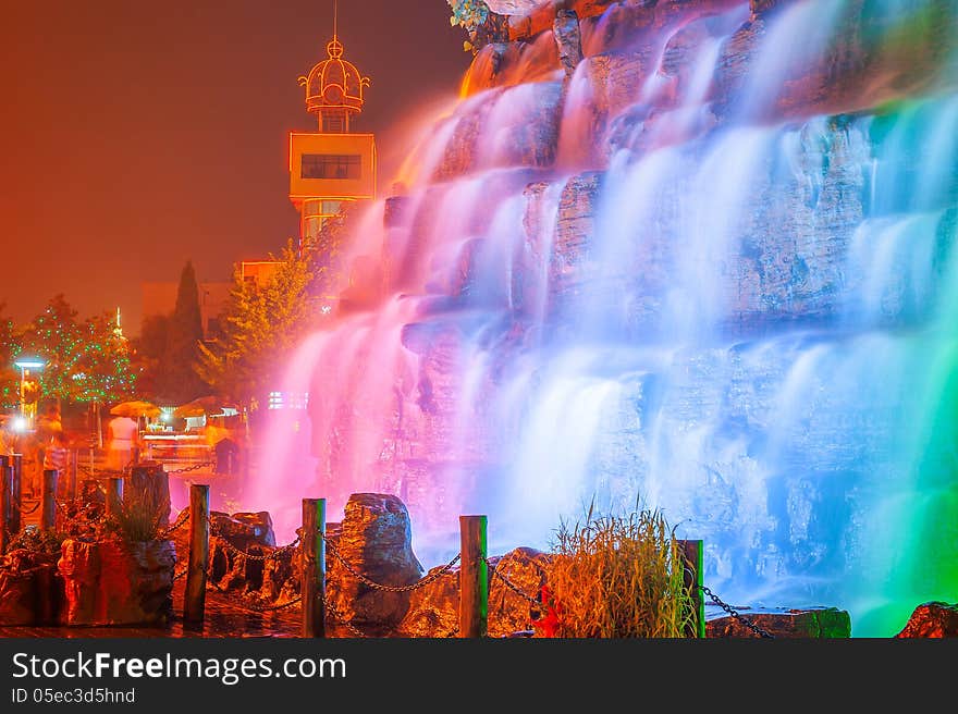 The image taken in china`s hebei province,qinhuangdao city,beidaihe district.At night colored lights illuminate the falls and create a charming turn away from. The image taken in china`s hebei province,qinhuangdao city,beidaihe district.At night colored lights illuminate the falls and create a charming turn away from.