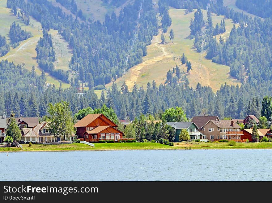 This is a photo of luxury vacation homes on Big Bear Lake with the grassy slopes of Snow Summit in the background. This is a photo of luxury vacation homes on Big Bear Lake with the grassy slopes of Snow Summit in the background.