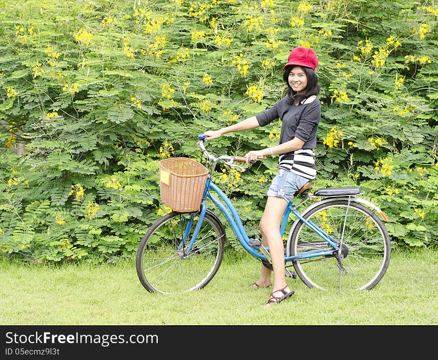 Smiling girl riding a bicycle in the park