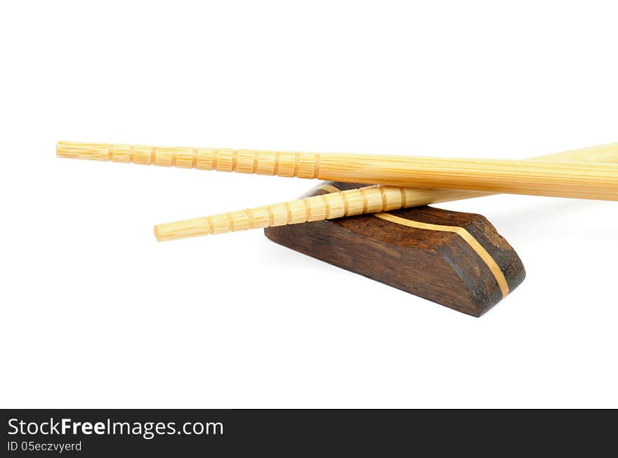 Pair of Beige Chopsticks and Brown Hasioki Cross Section on white background