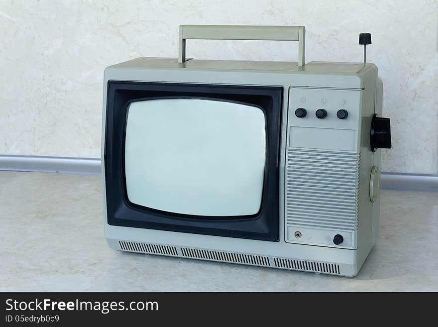 A small compact TV, outdated model