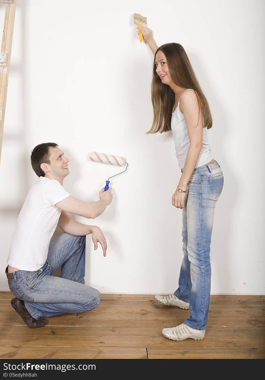 Portrait of happy family doing repair, parents with their son near ladder