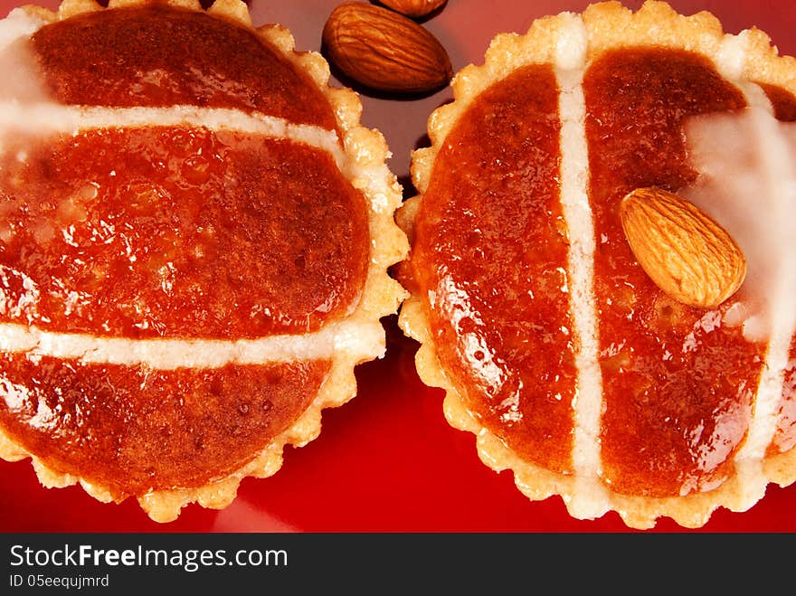 Almond cakes on a red dish with some almonds