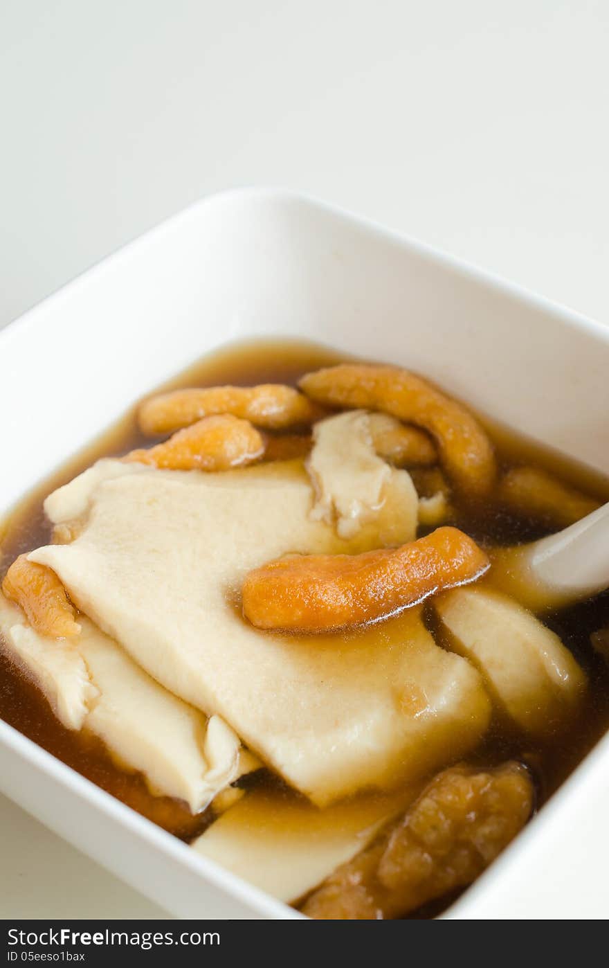 Chinese dessert made with white tofu serve with brown sugar and ginger.Sprinkle with Deep-fried dough stick known as Patongo. Chinese dessert made with white tofu serve with brown sugar and ginger.Sprinkle with Deep-fried dough stick known as Patongo