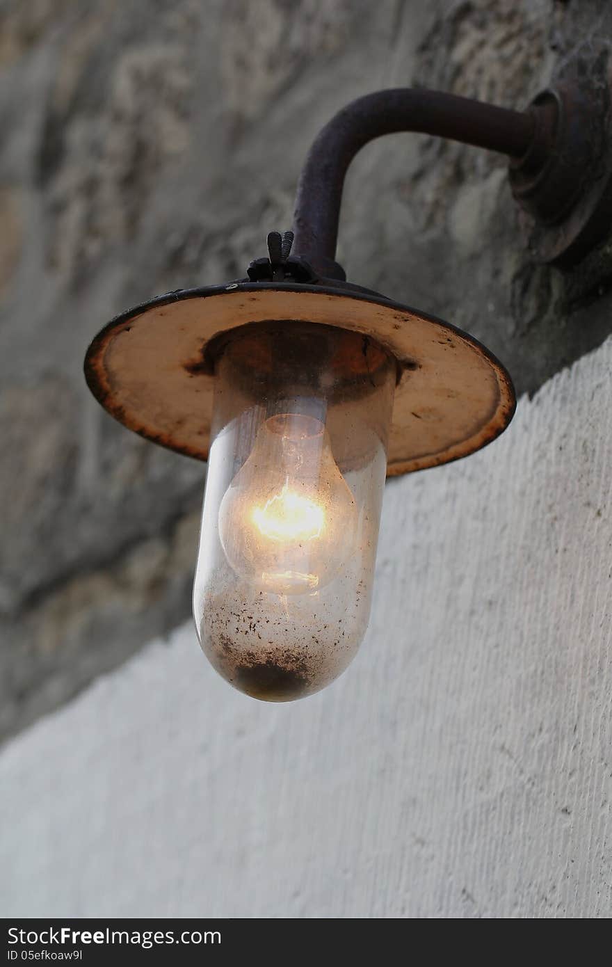 Old vintage rusty bulb lamp on wooden background. Old vintage rusty bulb lamp on wooden background