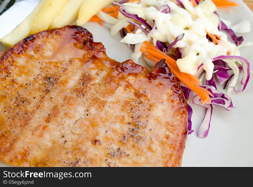 Pork steak with salad and French fries