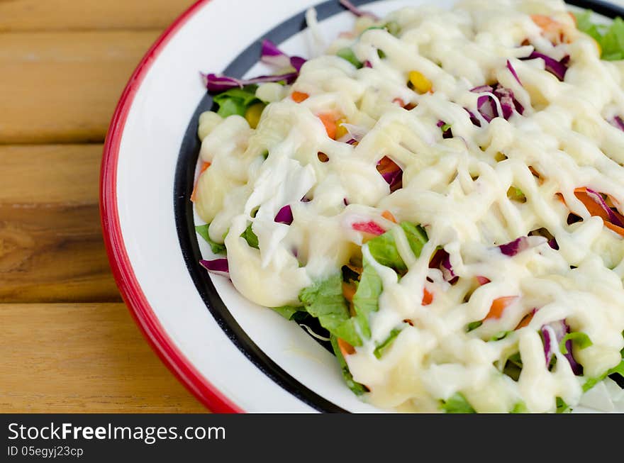 Fresh vegetable salad dressed with mayonnaise