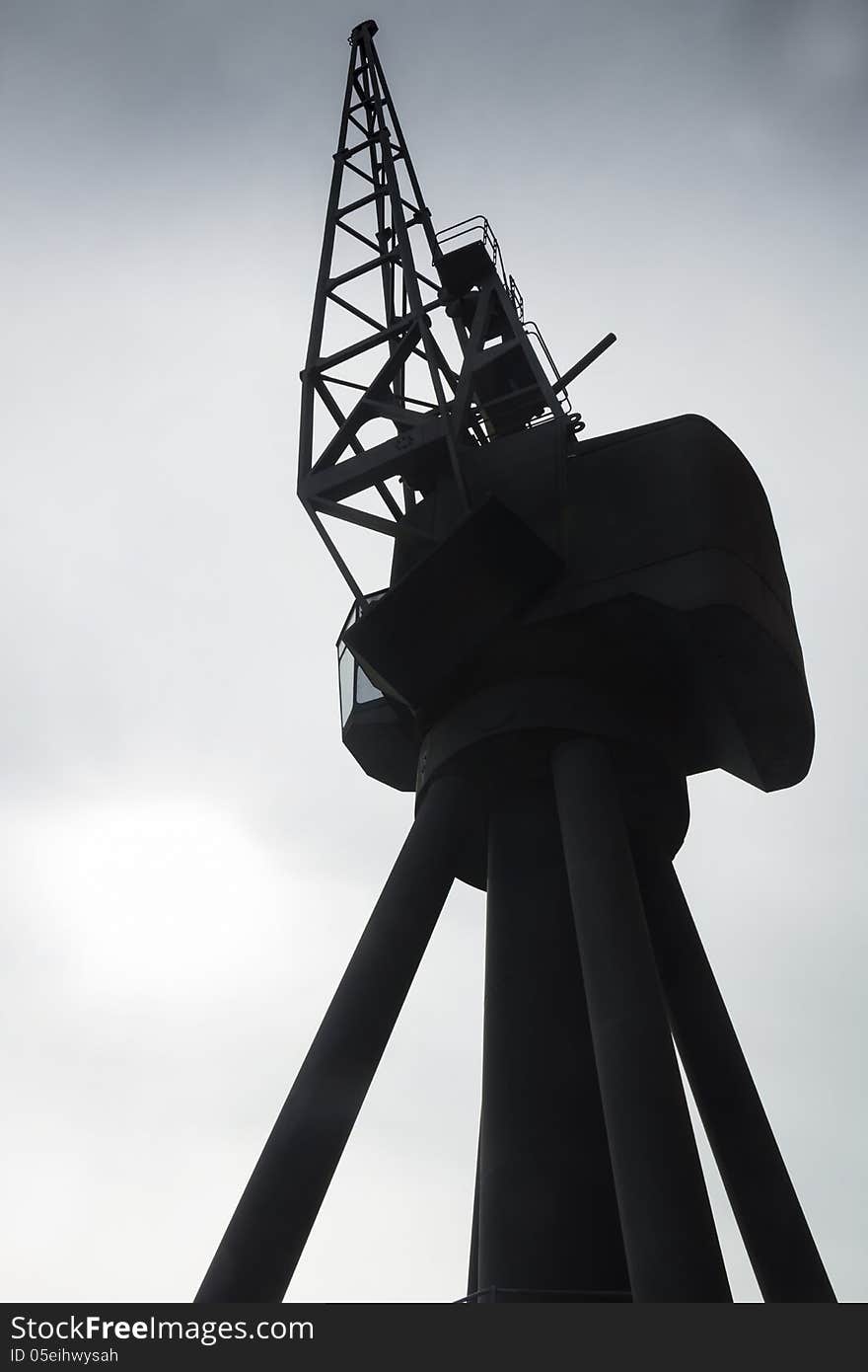 Industrial crane silhouetted against a moody sky. Industrial crane silhouetted against a moody sky