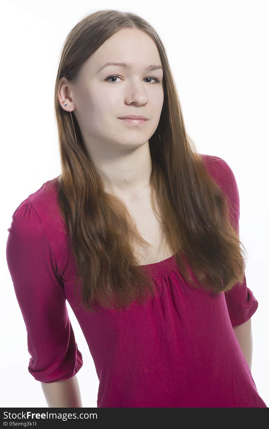 Portrait of young teen girl with long hair in pink