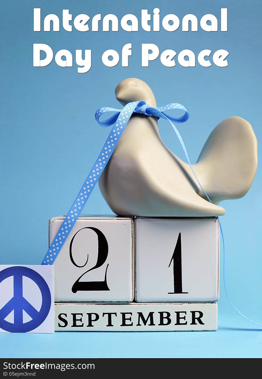 Dove and Peace Sign decorations for International Day of peace, World Peace Day, with white block calendar date on pale blue background. Dove and Peace Sign decorations for International Day of peace, World Peace Day, with white block calendar date on pale blue background.