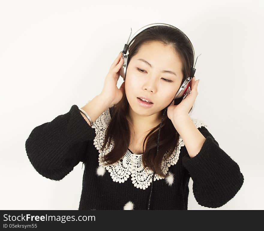 Young woman listening to music with headphones.