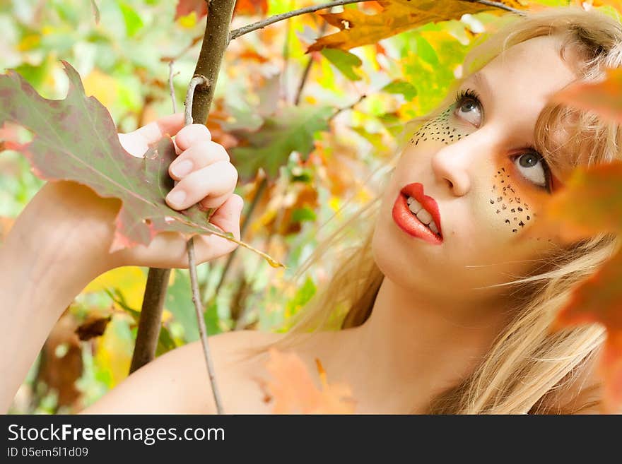 Teen is looking up in the forest