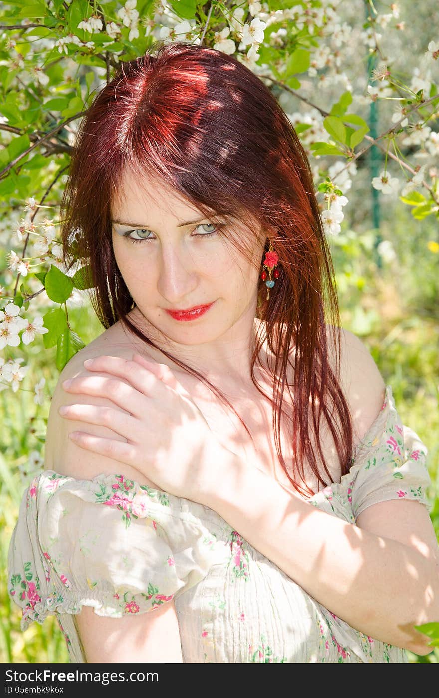 Portrait of young woman with cherry flowers.