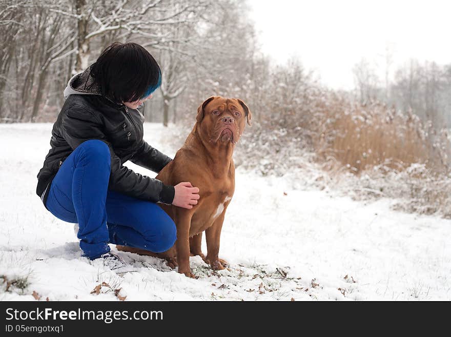 Funky boy is having fun with his dog in the snow. Funky boy is having fun with his dog in the snow