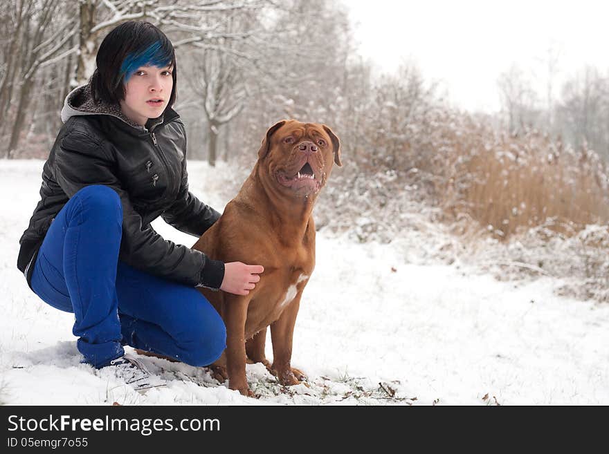 Funky boy is having fun with his dog in the snow. Funky boy is having fun with his dog in the snow