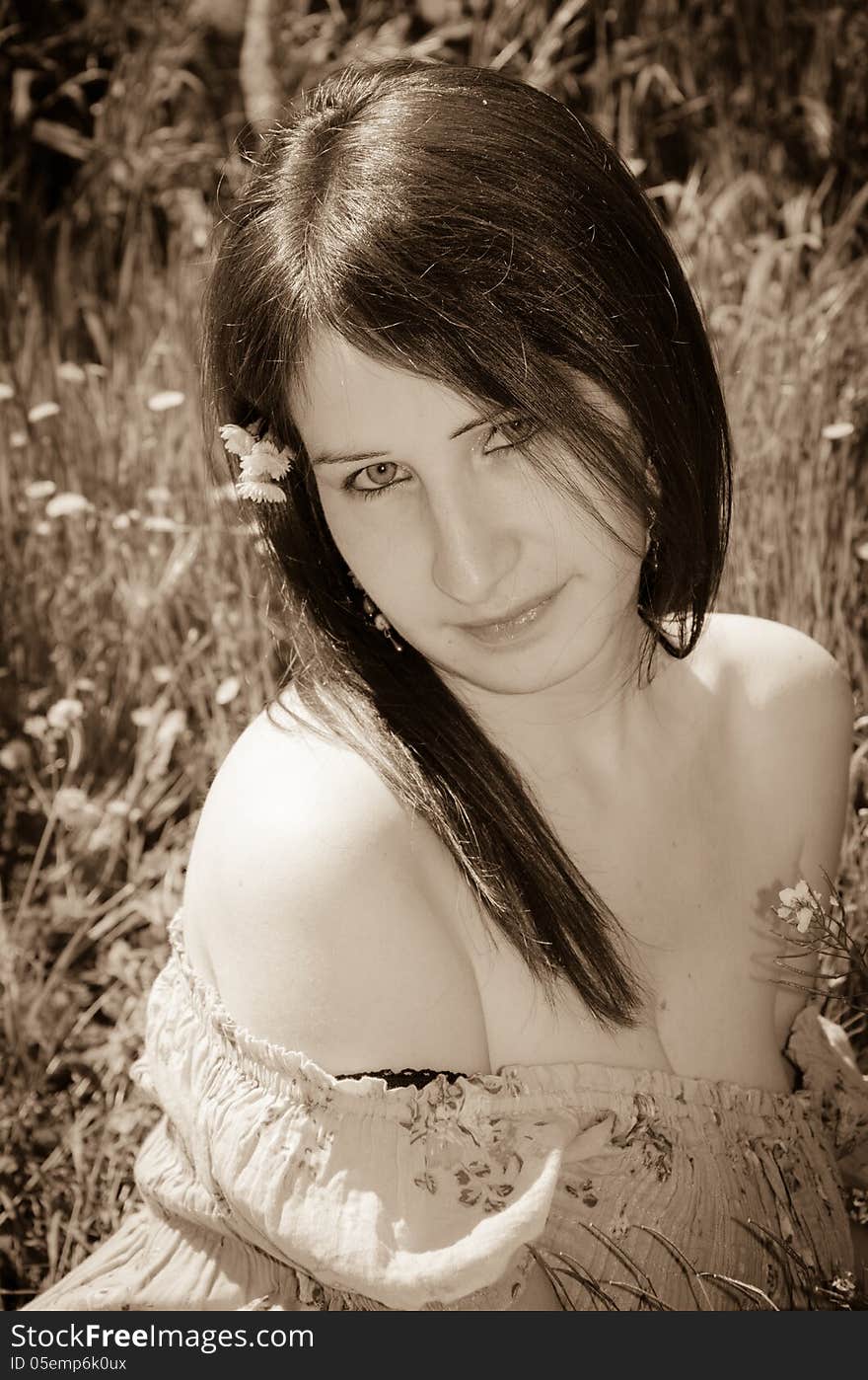 Young woman with flower in hair.