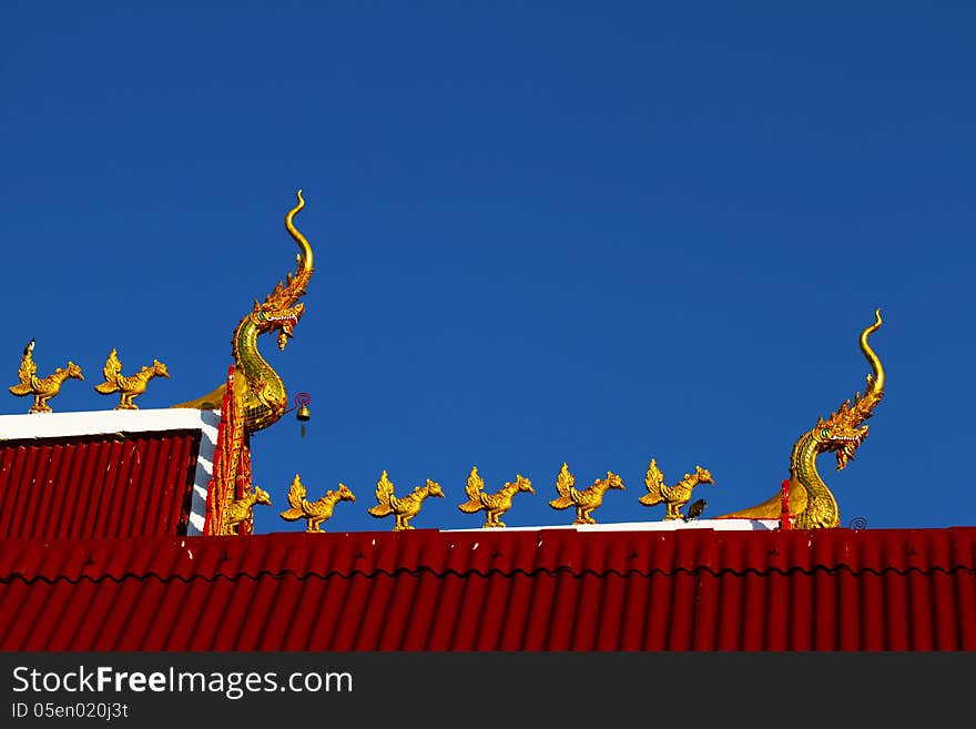 Heat dragon and statue chicken with bird at Wat Don keaw of Nan, Thailand