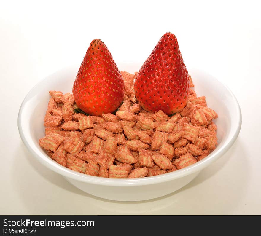 Two strawberries on a bowl of cereal. Two strawberries on a bowl of cereal.