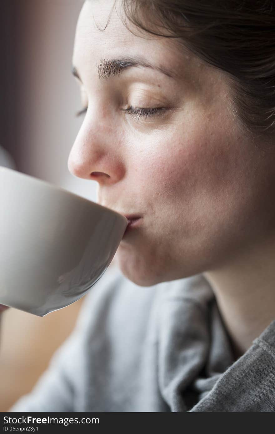 Beautiful Young Woman Holding Her Morning Cup of Coffee