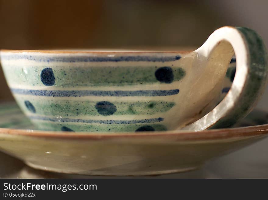 A whimsical cup and saucer with stripes and dots is an attractive addition to the kitchen table. A whimsical cup and saucer with stripes and dots is an attractive addition to the kitchen table.