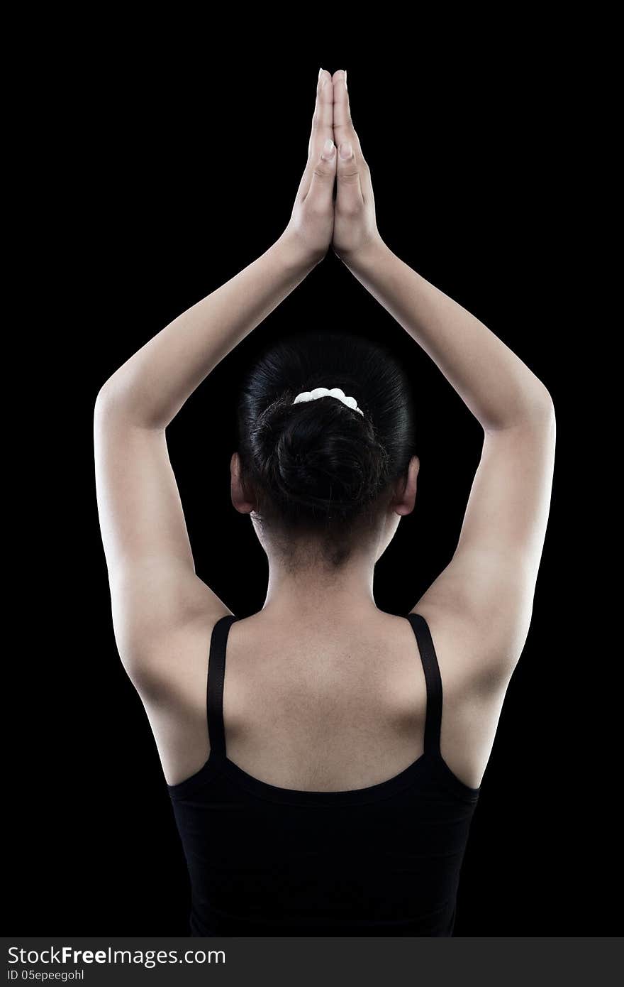 Back of Beautiful indian girl in black dress over on black background by joining their hands. Back of Beautiful indian girl in black dress over on black background by joining their hands