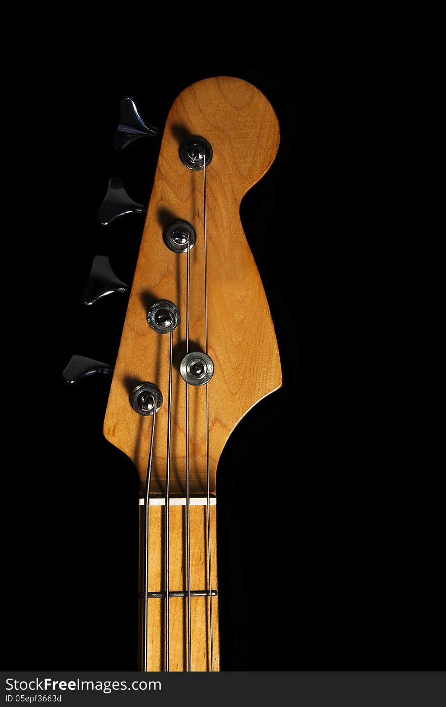 Bass guitar head. black background.close-up.