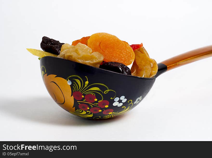 Spoon with fruit on a white background