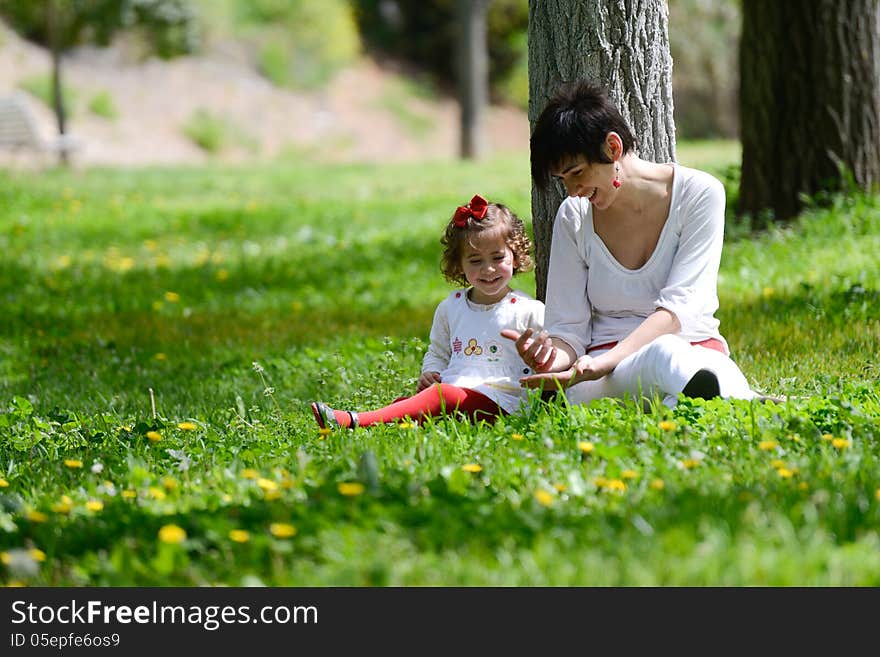 Mother and little girl playing in the park