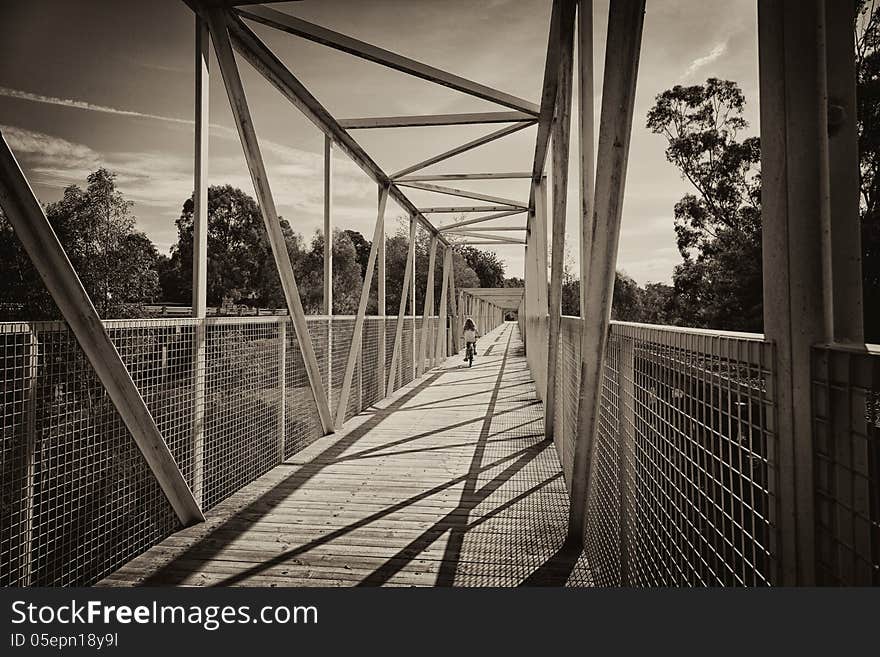 A child riding a bike along a bridge in Koonwarra, Australia.