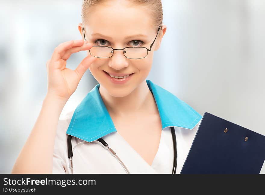 Friendly woman doctor smiling with folder in hand