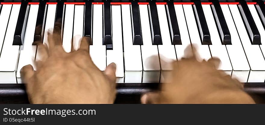 Hands on piano keyboard