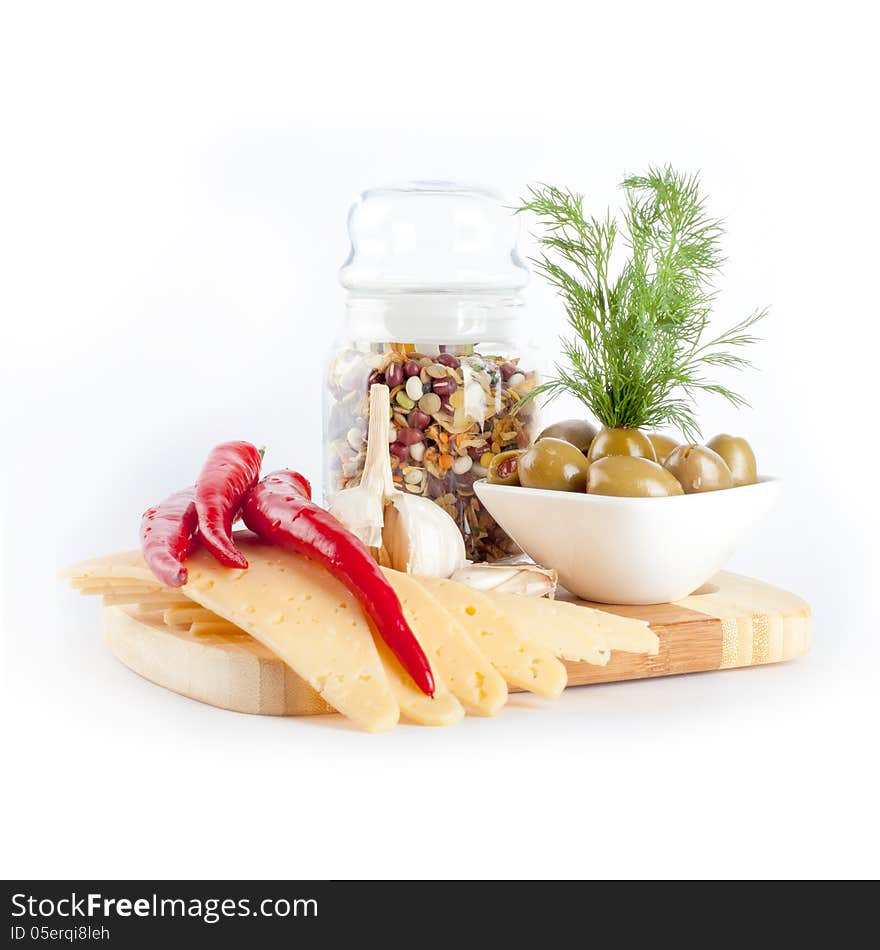 Cheese, bean soup, olives and chilli on a wooden board