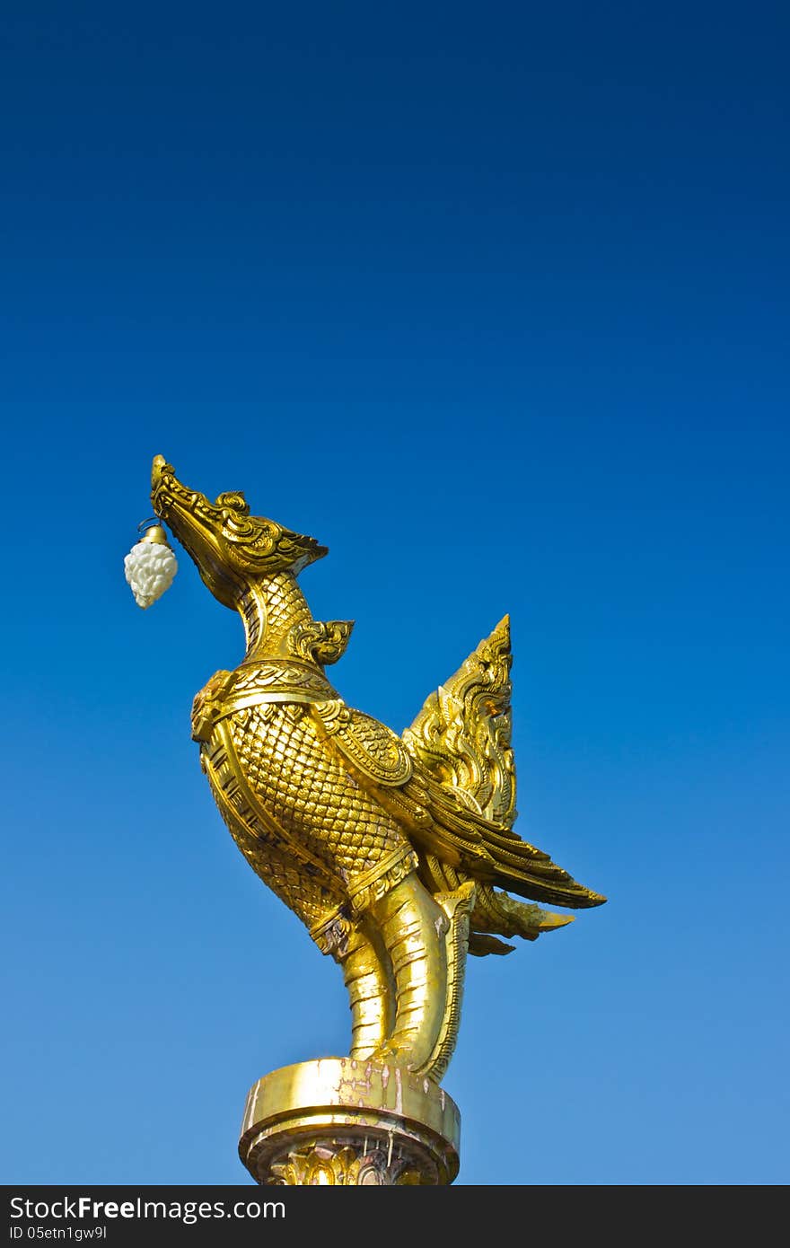 Statuary gold bird  on blue sky