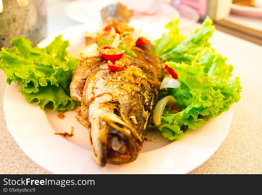 Fired fish with fresh herds delicious Thai food. Fired fish with fresh herds delicious Thai food