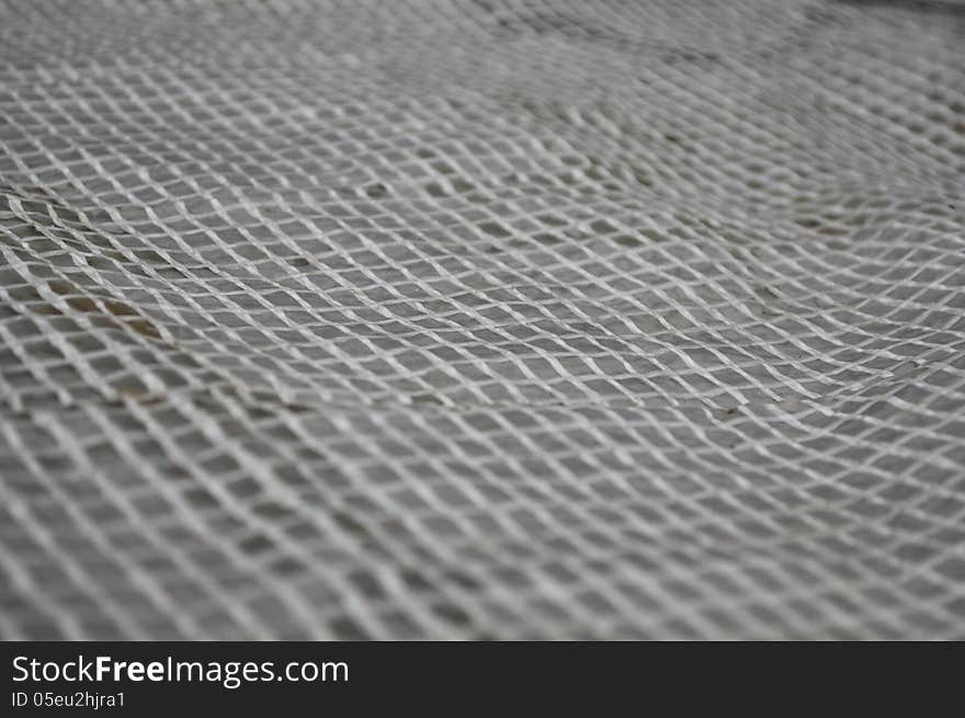 Light Wicker Grille On A Gray Background.