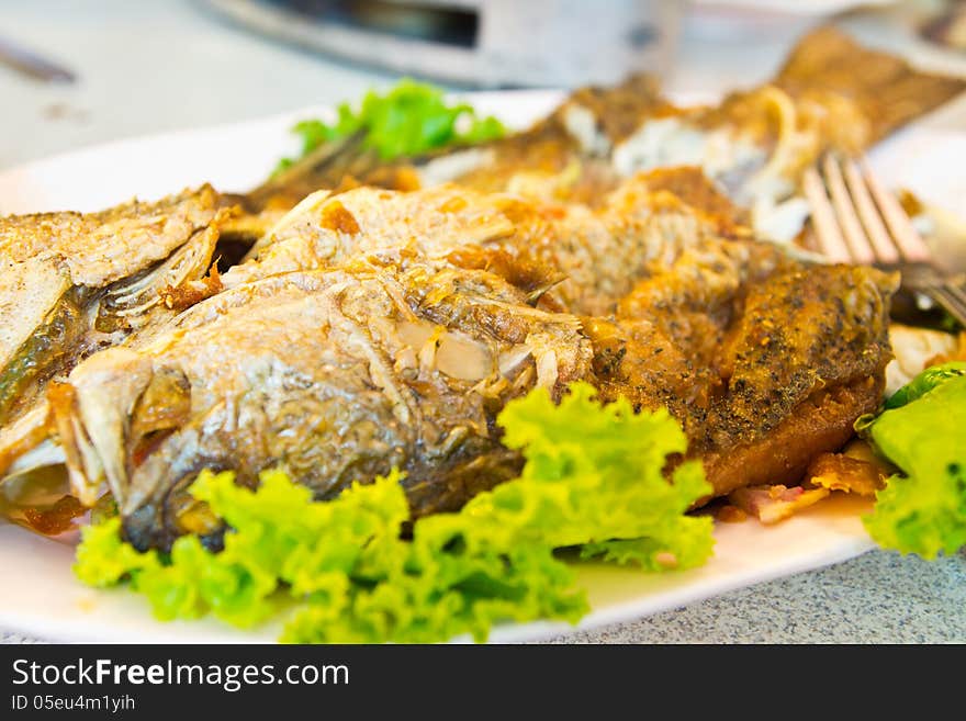 Fried Fish on dish with vegetables,Style Thailand. Fried Fish on dish with vegetables,Style Thailand