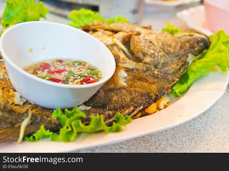 Fried Fish on dish with vegetables and pepper Sauce,Style Thailand. Fried Fish on dish with vegetables and pepper Sauce,Style Thailand