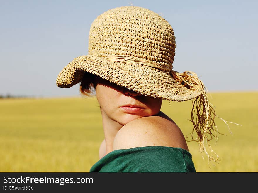 Pretty woman in the hat in golden wheat. Pretty woman in the hat in golden wheat