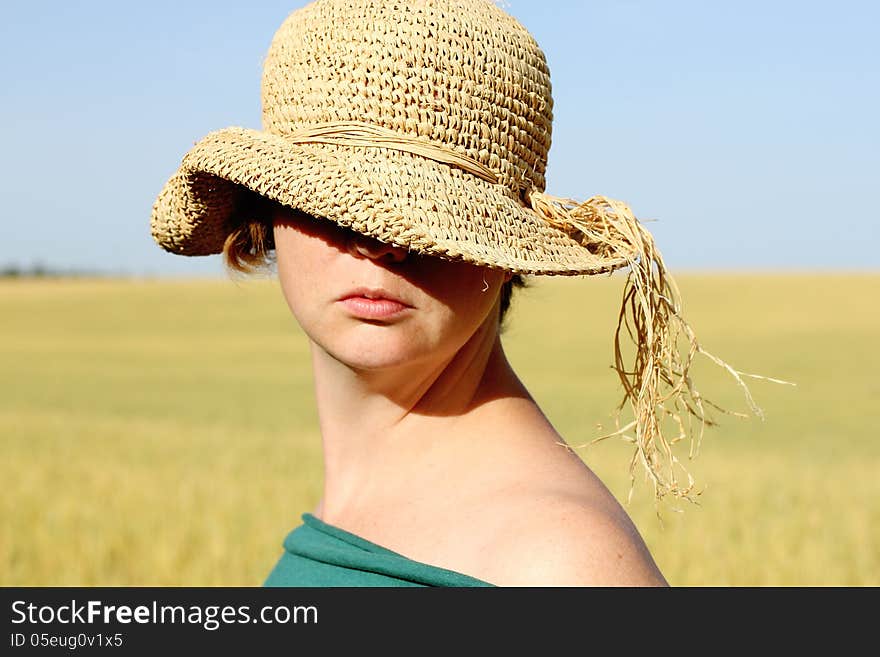 Pretty woman in the hat in golden wheat. Pretty woman in the hat in golden wheat