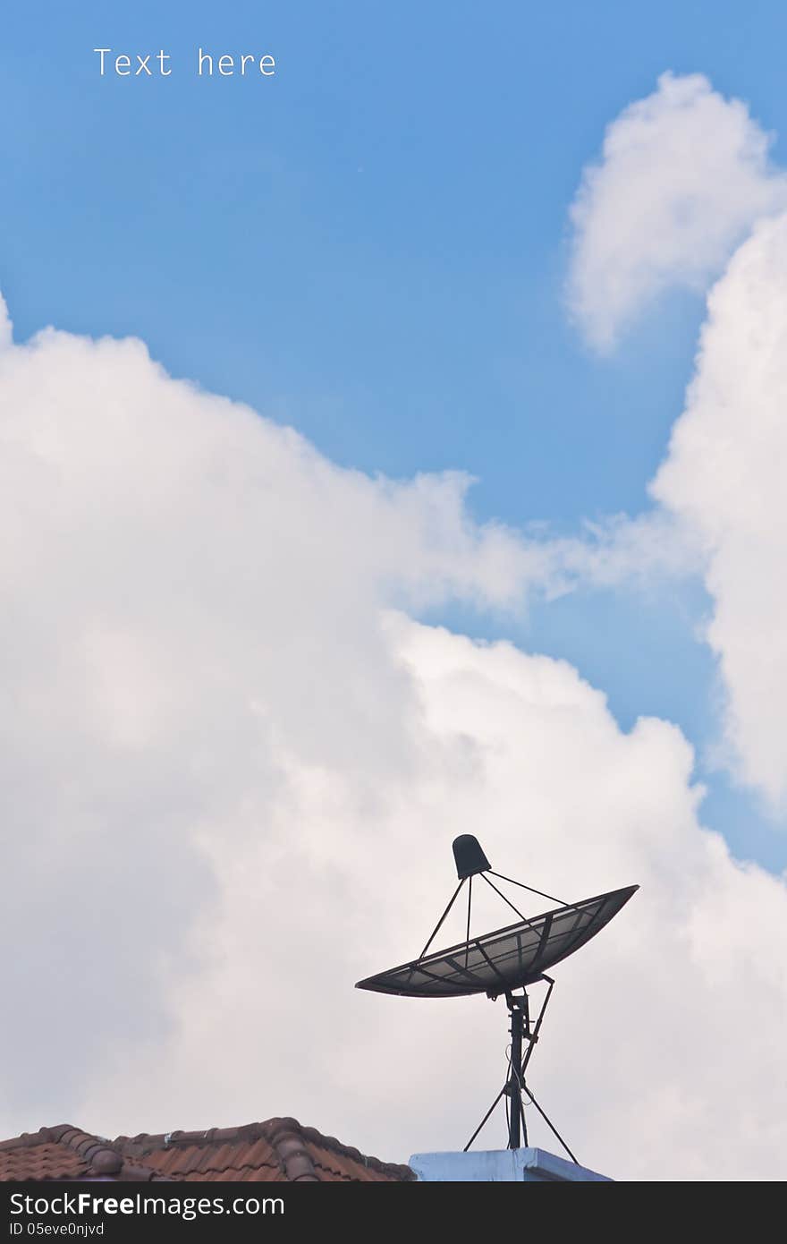 Satellite dish and cloudy blue sky