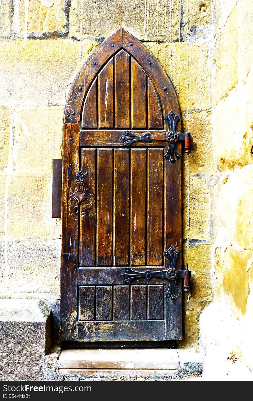 Wooden medieval church door with iron hingies