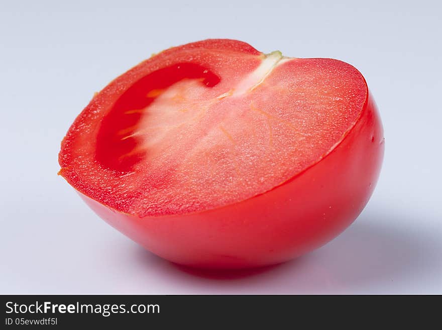 Tomato cut in half on white background